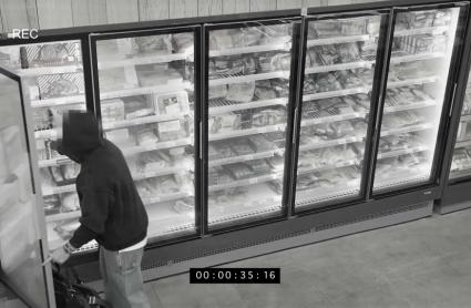 Robo en un establecimiento - Imagen de archivo.