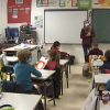 Alumnos de Primaria del colegio Castra Caecilia de Cáceres en su regreso hoy a las aulas. Imagen del interior de un aula con alumnos en sus pupitres y su profesora al pie de la pizarra.