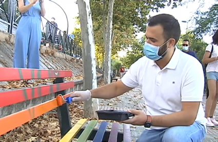 El alcalde de Cáceres Luis Salaya pintando un banco vandalizado con las siglas de VOX