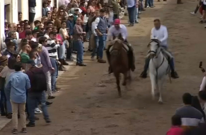 Dos jinetes galopan en la calle Corredera de Arroyo de la Luz